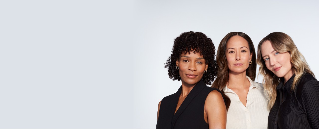 Three female JUVÉDERM pateints pose in front of a blank wall.