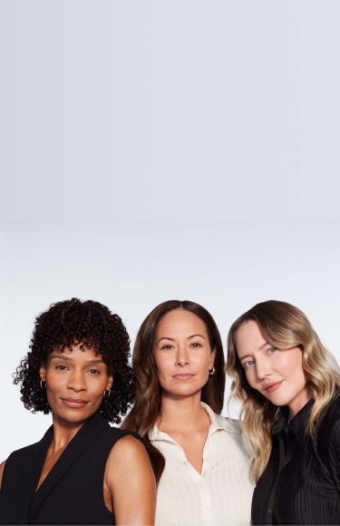 Three female JUVÉDERM pateints pose in front of a blank wall.